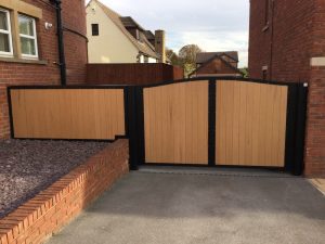 A close-up image of a composite board swing gate with a modern design, showcasing the craftsmanship of Mustang Fencing and Gates.