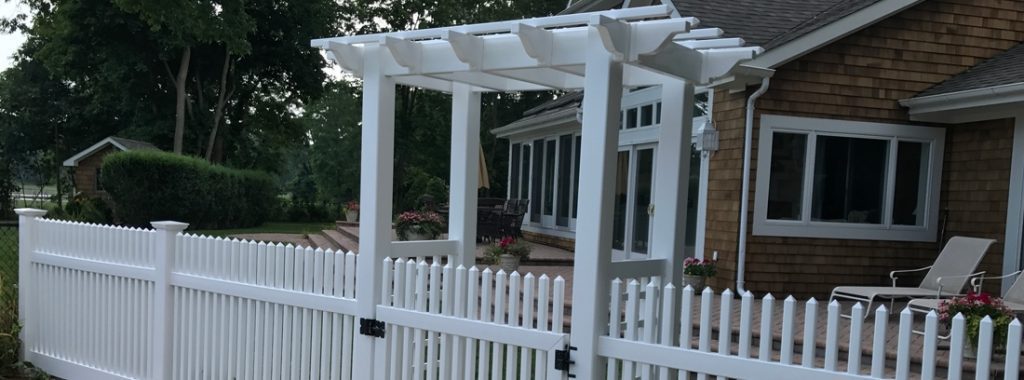 vinyl-fence-gate - Mustang Fencing and Gates A white vinyl fence gate with a decorative design, installed by Mustang Fencing and Gates.