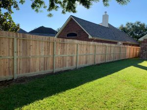 A modern black metal fence with a geometric design, installed by Mustang Fencing and Gates.