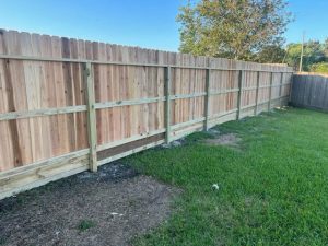 A 213-foot cedar fence being built for Elaine and Steve Athanasiou in Santa Fe, TX by Mustang Fencing and Gates.
