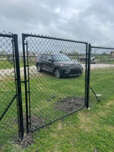 "Black chain link fence installed in Houston, Texas by Mustang Fencing and Gates."