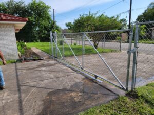 "Chain link gate installation in Houston, TX by Mustang Fencing and Gates."