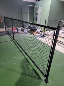 "Professional installation of a chain-link fence in Houston by Mustang Fencing and Gates."