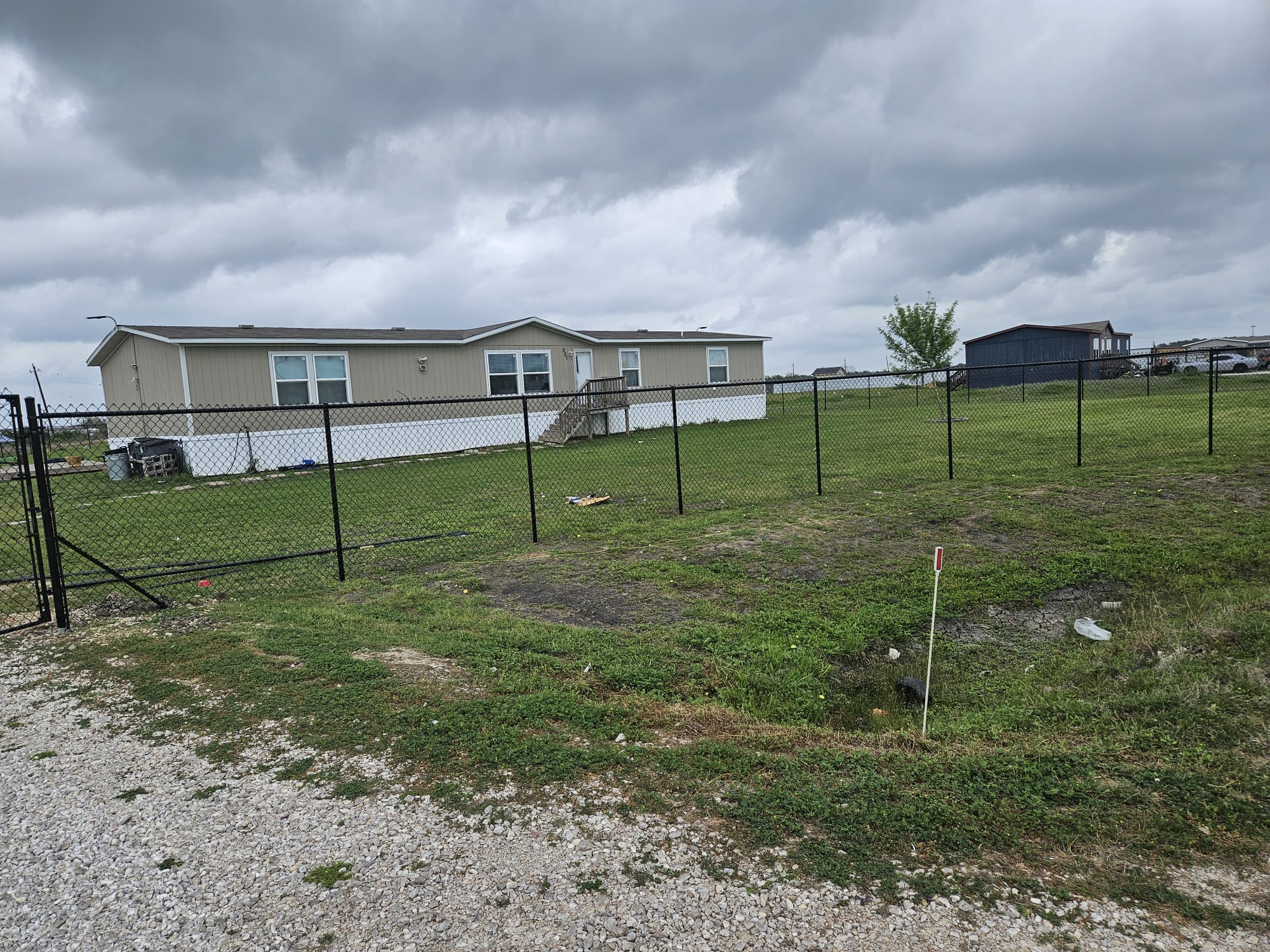 Galvanized chain-link fence around a residential Houston yard