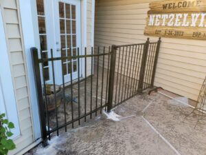 "Decorative metal gate serving as an elegant patio entrance in Houston."