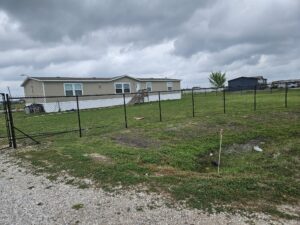 "Chain link fence surrounding a yard in Houston, TX, installed by Mustang Fencing and Gates."