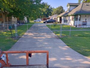 "Chain link gate installed in a driveway yard in Houston, TX by Mustang Fencing and Gates."