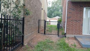 "Custom metal gate and fence in Houston, TX, showcasing intricate design and high-quality craftsmanship by Mustang Fencing and Gates."