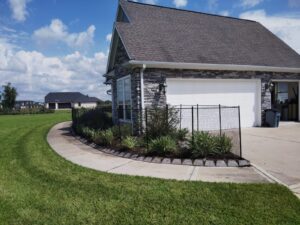 "Garden fence and garage in Houston, TX by Mustang Fencing and Gates."