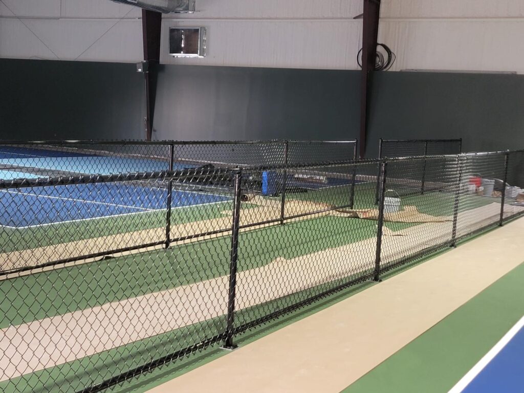 indoor tennis court chain link fence houston tx - Mustang Fencing and Gates "Indoor tennis court enclosed by a chain-link fence in Houston, TX."