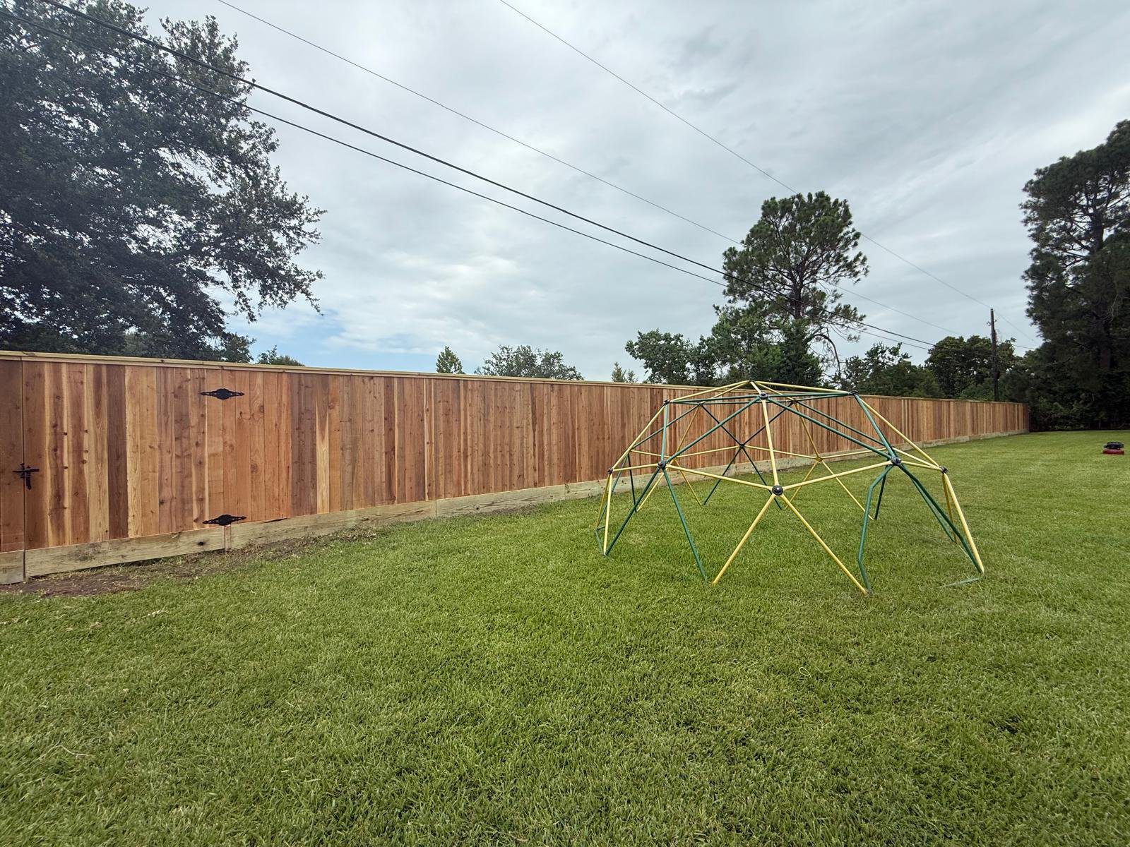 Cedar fence along a shared residential property line in the Houston area