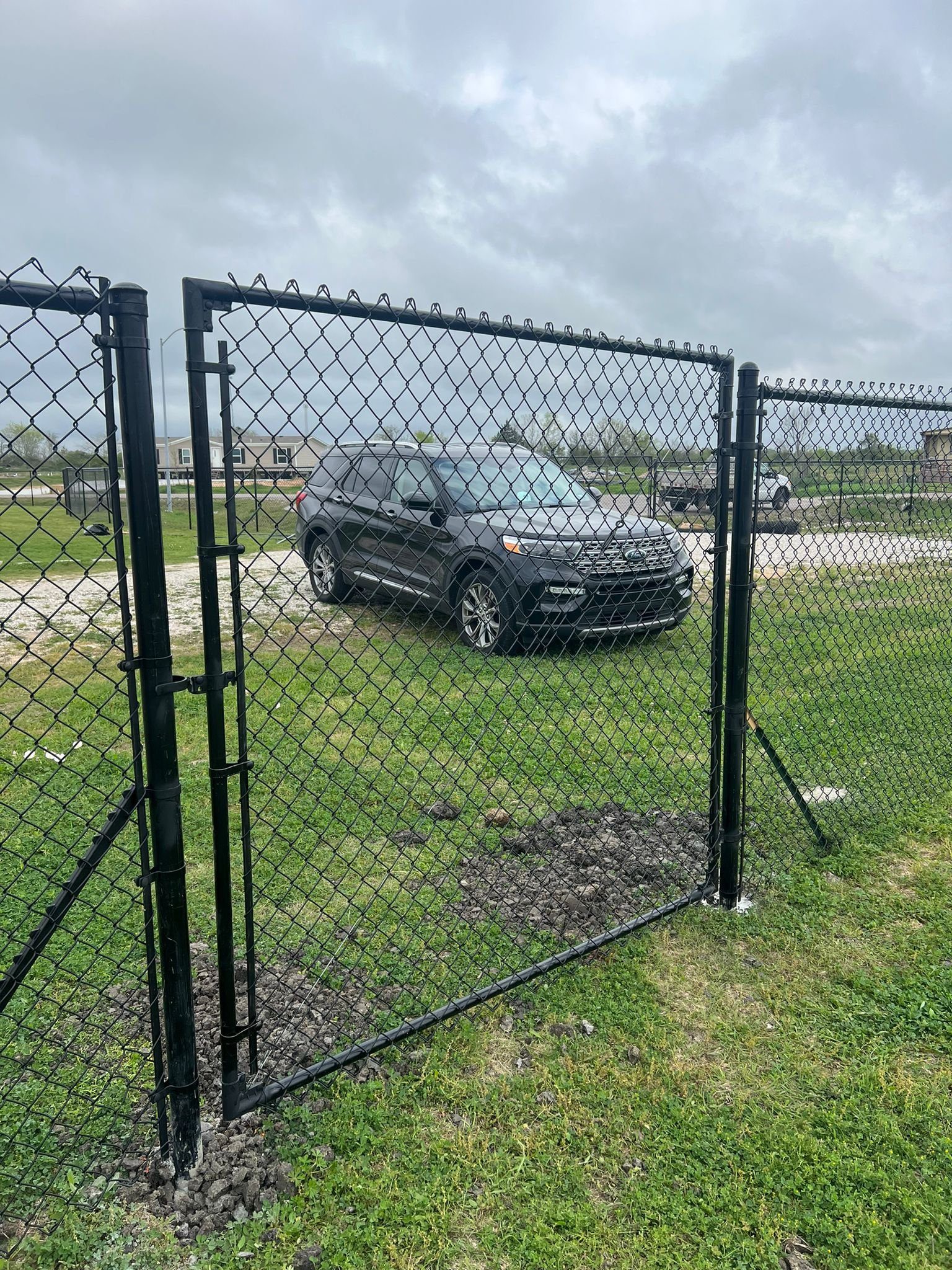 Black chain link security fence in Houston, TX by Mustang Fencing and Gates