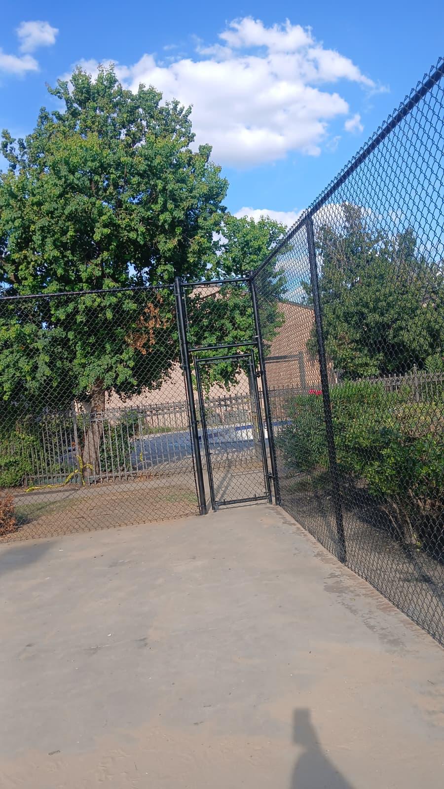 A gated pedestrian entrance controls access to a multi-tenant community's amenity area.